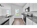 Modern kitchen with granite countertops and stainless steel appliances at 16610 Sw 50Th Cir, Ocala, FL 34473