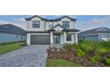 Two-story home with a gray brick driveway at 485 Adams View Ln, Auburndale, FL 33823