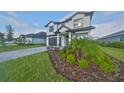 Two-story home with a gray brick driveway at 485 Adams View Ln, Auburndale, FL 33823