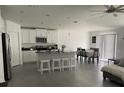 Open concept kitchen with island and stainless steel appliances at 6945 Church Lake St, Groveland, FL 34736