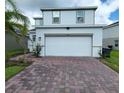Two-story house with white siding and a two-car garage at 1564 Eucalyptus Way, Davenport, FL 33837