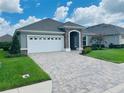 One-story home with a two-car garage and landscaped lawn at 7771 Lake James Blvd, Lakeland, FL 33810
