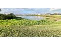 Calm lake view with a row of houses and lush vegetation at 210 Kenny Blvd, Haines City, FL 33844