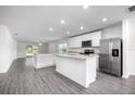 Modern kitchen with stainless steel appliances and an island at 16448 Sw 17Th Terrace Rd, Ocala, FL 34473
