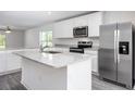 Modern kitchen with stainless steel appliances and an island at 16448 Sw 17Th Terrace Rd, Ocala, FL 34473