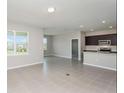 Open kitchen with island, stainless steel appliances, and dark brown cabinets at 8322 Sw 52Nd Lane Rd, Ocala, FL 34481