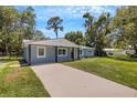 Newly renovated light blue home with a driveway and large yard at 3419 Lisa Ln, Lakeland, FL 33801