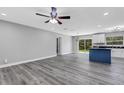 Open living room and kitchen with gray vinyl flooring at 3419 Lisa Ln, Lakeland, FL 33801