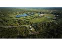 Aerial view showing home's location near golf course at 7811 Red Grange Blvd, Indian Lake Estates, FL 33855