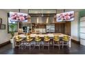 Modern community kitchen with large island, stainless steel appliances, and tv screens at 4083 Nw 44Th Cir, Ocala, FL 34482