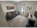 Cozy bedroom with gray sofa and workspace at 319 Hibiscus Dr, Kissimmee, FL 34759