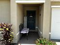 Covered front porch with bench and decorative accents at 319 Hibiscus Dr, Kissimmee, FL 34759