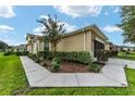 Tan house with walkway, landscaping, and outdoor lighting at 7067 Sw 91St Ct, Ocala, FL 34481