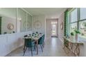 Bright dining room featuring a modern table and stylish green chairs at 4063 Nw 44Th Cir, Ocala, FL 34482