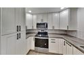 Modern kitchen with white shaker cabinets and sleek countertops at 1737 Jacobs Rd, South Daytona, FL 32119