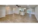 Open concept living area with new flooring and a breakfast bar at 1737 Jacobs Rd, South Daytona, FL 32119