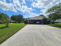 Two-car carport with driveway and surrounding landscape at 1140 E George St, Bartow, FL 33830