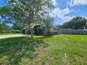 Side view of the house with a large yard and fenced area at 1140 E George St, Bartow, FL 33830