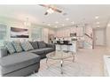 Open floor plan with L-shaped sofa and kitchen island at 2174 Fleming Mist Pl, Kissimmee, FL 34747