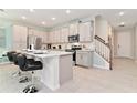 Modern kitchen with an island and stainless steel appliances at 2174 Fleming Mist Pl, Kissimmee, FL 34747