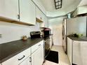 Bright kitchen features white cabinets, dark countertops, and stainless steel appliances at 540 Francis Blvd, Lakeland, FL 33801