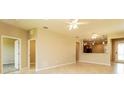 Open living space with tile floors, kitchen views, and access to other rooms at 406 Tortosa Ct, Davenport, FL 33837