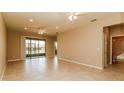 Spacious living area featuring tile floors, access to a patio, and neutral wall colors at 406 Tortosa Ct, Davenport, FL 33837