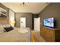 Spacious bedroom with king-size bed, TV, and ensuite bathroom access at 2857 Bookmark Dr, Kissimmee, FL 34746