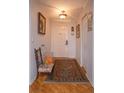 Light and airy entryway with hardwood floors and area rug at 1 John Anderson Dr # 604, Ormond Beach, FL 32176