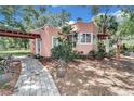 Spanish style home with a walkway, landscaping and pergola at 8901 Nw 136Th Avenue Rd, Ocala, FL 34482