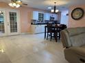 Open living room and kitchen with light flooring and a comfortable couch at 10566 Cr 671, Bushnell, FL 33513