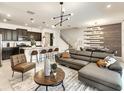 Open concept living room with modern furniture and a kitchen at 7472 Oakmoss Loop, Davenport, FL 33837
