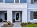 Inviting exterior of a light blue two-story home with a gray walkway at 7472 Oakmoss Loop, Davenport, FL 33837
