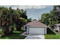 Newly built home with a two-car garage and landscaped yard at 604 W 12Th St, Lakeland, FL 33805