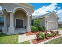 House entrance with double doors and lush landscaping at 4046 Dinner Lake Way, Lake Wales, FL 33859