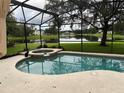 Relaxing pool and spa area with a view of a lake at 12609 Oulton Cir, Orlando, FL 32832