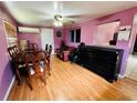 Dining area with wooden table and chairs, hardwood floors, and a living area at 6004 Hilltop E Ln, Lakeland, FL 33809