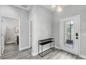 Modern entryway with gray tile floors, a console table, and half bath at 1126 Whitewater Bay Dr, Groveland, FL 34736