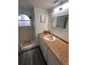 Bathroom with shower, vanity, and updated flooring at 2729 N Poinciana Blvd # 117, Kissimmee, FL 34746
