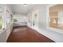 Inviting front porch with wood flooring and ample natural light at 450 Avenue B Ne, Winter Haven, FL 33881