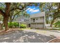 Modern two-story house with a balcony and gravel driveway at 6318 Cedar Ln, Lakeland, FL 33813