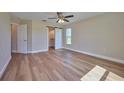 Large bedroom with wood-look flooring and access to bathroom at 7031 Red Grange Boulevard Ave, Indian Lake Estates, FL 33855