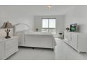 Bright bedroom with a queen-size bed, white dresser, and marble floors at 231 Riverside Dr # 709, Daytona Beach, FL 32117