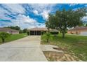 Single-story house with two-car garage and yard at 6023 Country Walk Ln, Winter Haven, FL 33880