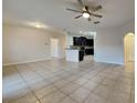 Open living room and kitchen area with tile flooring at 2217 Betsy Ross Ln # A, St Cloud, FL 34769
