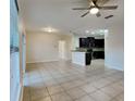 Open living room and kitchen area with tile flooring at 2217 Betsy Ross Ln # A, Saint Cloud, FL 34769