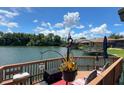 Deck with seating area overlooking a calm river under a bright sky at 696 Caribbean Dr, Lakeland, FL 33803
