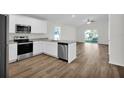 Modern kitchen with stainless steel appliances and white cabinets at 17691 Sw 36Th Avenue Rd, Ocala, FL 34473