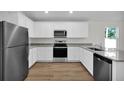 Modern kitchen with stainless steel appliances and white cabinets at 17691 Sw 36Th Avenue Rd, Ocala, FL 34473