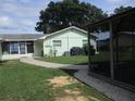 Backyard with a covered patio and a walkway leading to a screened enclosure at 10742 W Beach Pkwy, Lake Wales, FL 33898